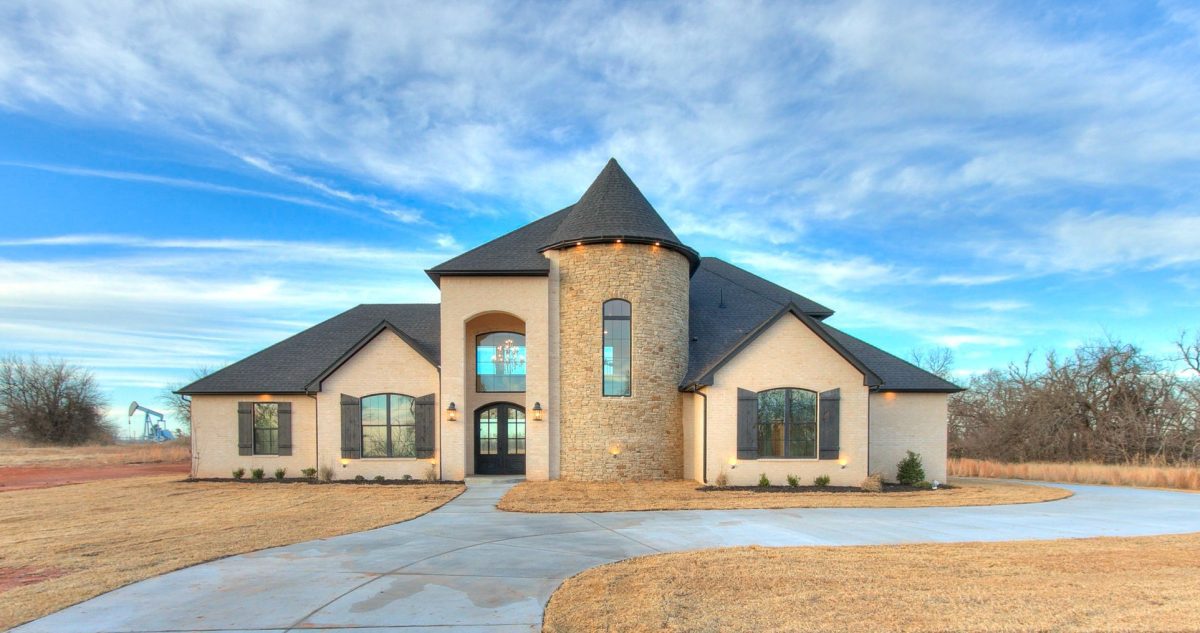 The the light colored front exterior of a home with black accents.