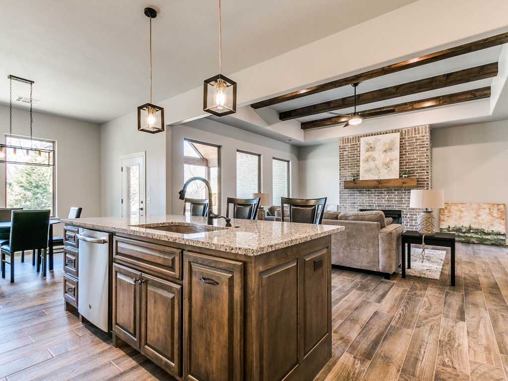 view of kitchen island/breakfast bar with built-in sink and dishwasher