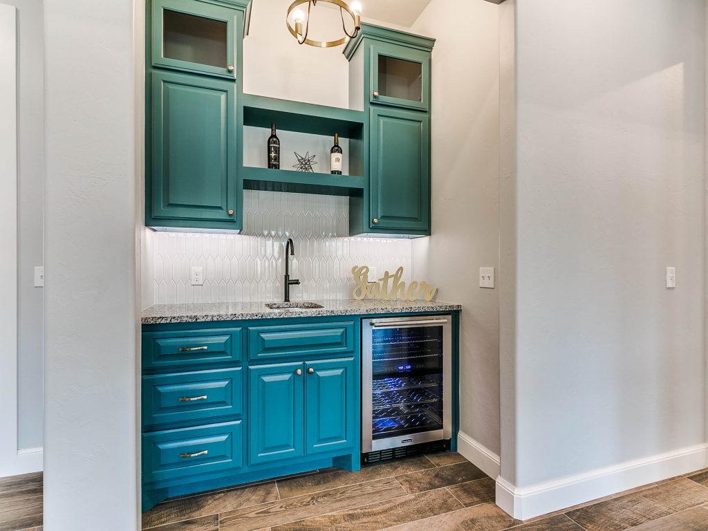 wine nook with sink, cabinets, wine cooler