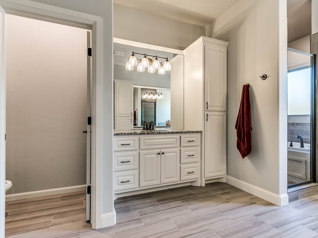 bathroom with vanity, sink, and toilet room